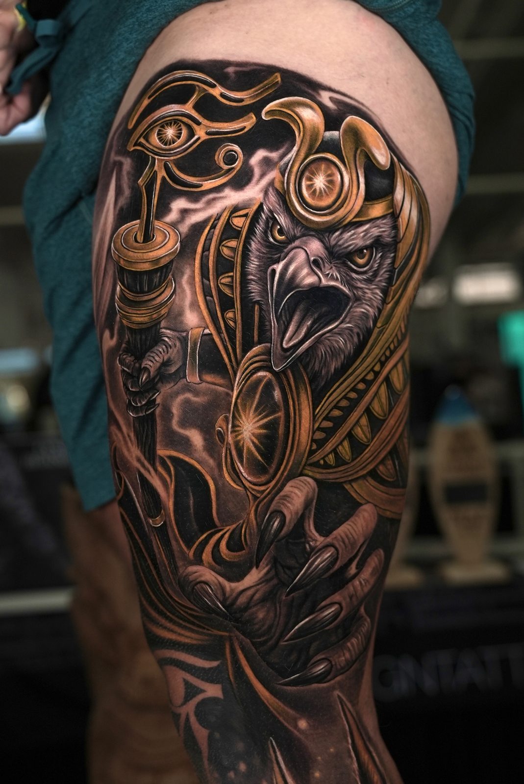 Color realism Egyptian Horus leg sleeve tattoo with gold armor and Eye of Ra